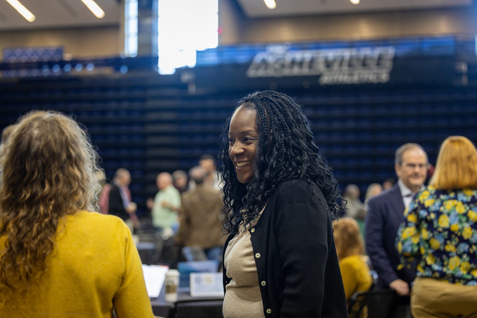 Educator smiling during conversation at Brainhub