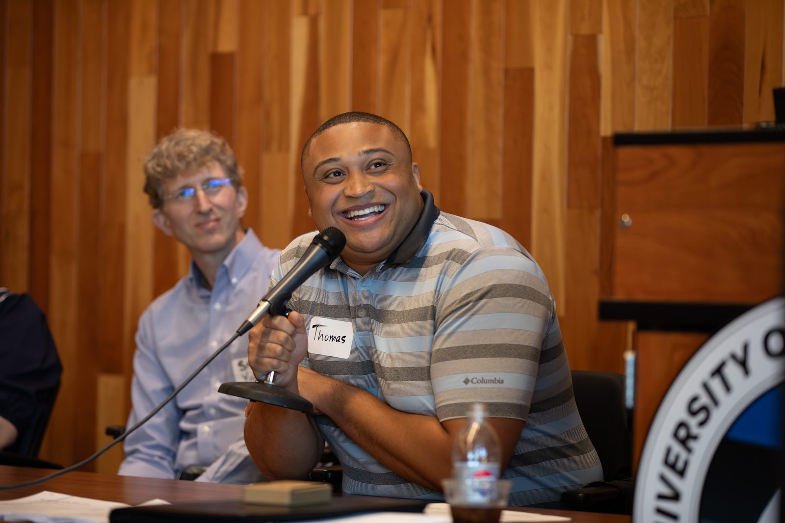 Panelist smiling while speaking into a microphone at the January AI Summit