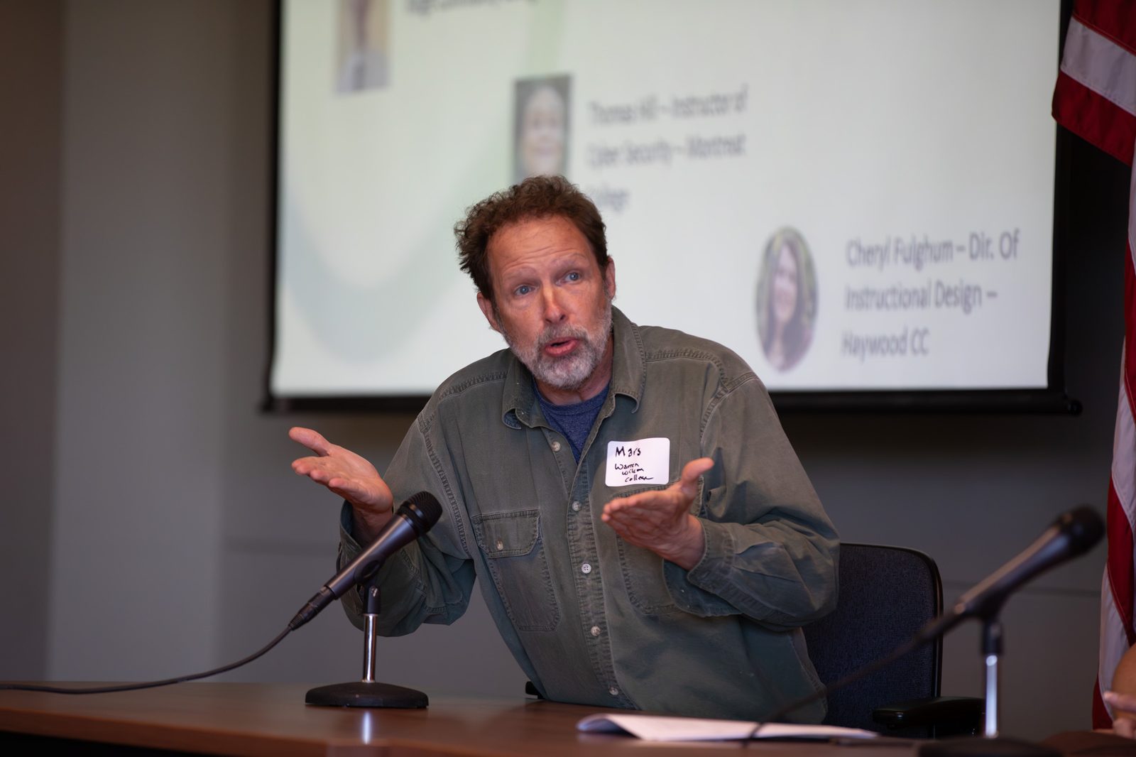 Educator speaking with campus partners on screen behind
