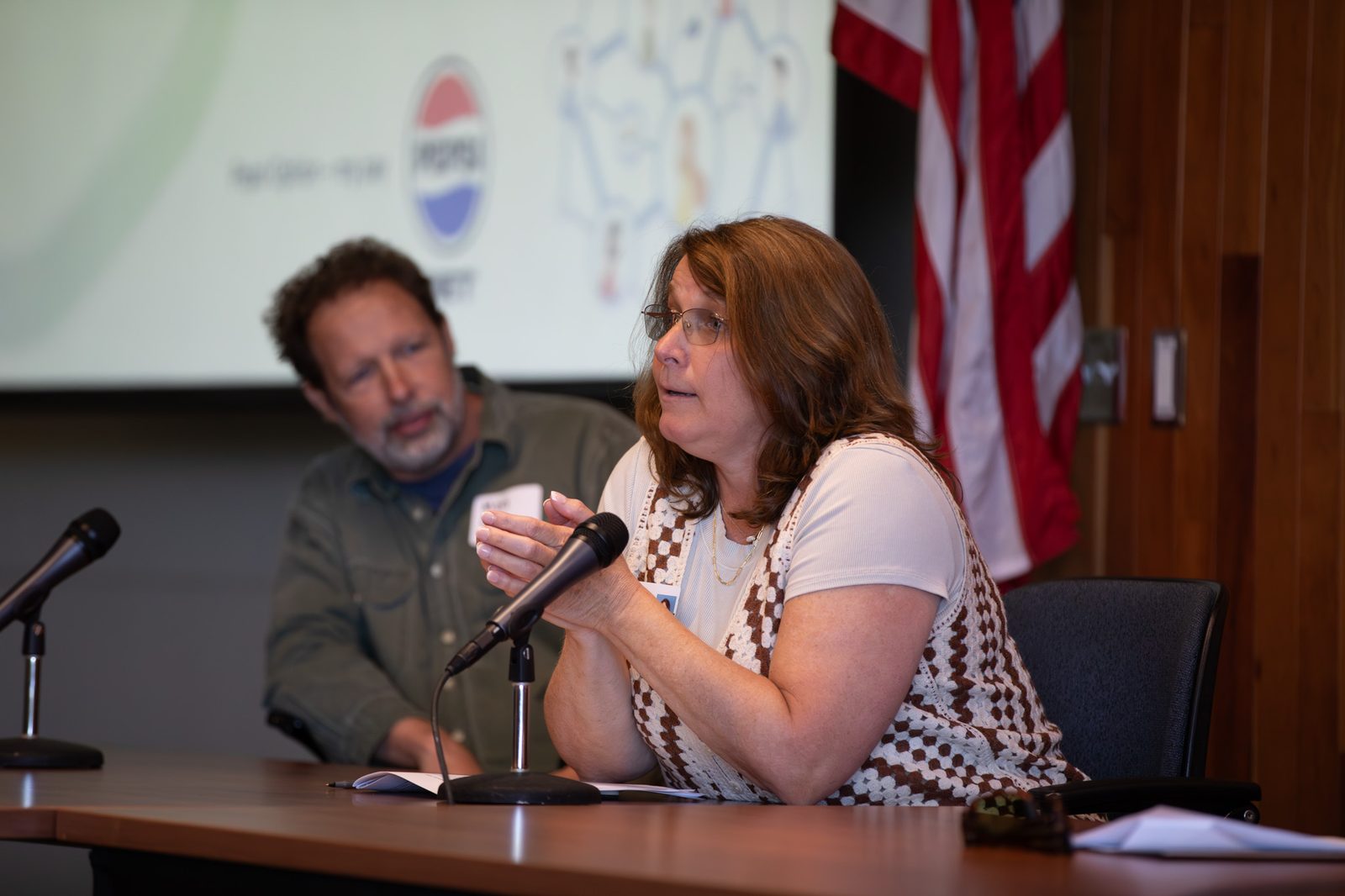 Educator speaking into a microphone at Brainhub